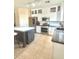 Modern kitchen featuring white cabinets, stainless steel appliances, an island, and a stylish backsplash for a sleek design at 1516 E Azalea Dr, Gilbert, AZ 85298