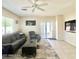 Inviting living room with a comfortable sofa, ceiling fan, and sliding door to outdoor space at 1516 E Azalea Dr, Gilbert, AZ 85298
