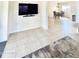 Open living room with tile flooring, modern mounted television, and view of the adjacent dining area at 1516 E Azalea Dr, Gilbert, AZ 85298