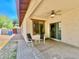 Covered patio with ceiling fan, seating, and sliding glass doors for easy indoor/outdoor living at 1516 E Azalea Dr, Gilbert, AZ 85298