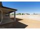 Large backyard with covered patio, and privacy wall at 15656 W Mercer Ln, Surprise, AZ 85379