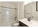 Bathroom with a shower-tub combo, and stylish vanity with a modern faucet at 15656 W Mercer Ln, Surprise, AZ 85379