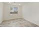 Well-lit bedroom featuring tile floors, a large window and bright lighting at 15656 W Mercer Ln, Surprise, AZ 85379