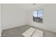 Bright bedroom with carpet flooring and a large window providing natural light at 15656 W Mercer Ln, Surprise, AZ 85379