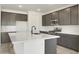 Stylish kitchen with dark cabinets, a spacious center island, and stainless steel appliances at 15656 W Mercer Ln, Surprise, AZ 85379