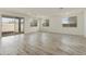 Bright living room featuring tile floors, recessed lighting, and large sliding glass doors to the backyard at 15656 W Mercer Ln, Surprise, AZ 85379