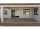Covered patio with concrete floor and sliding door to the house at 15656 W Mercer Ln, Surprise, AZ 85379