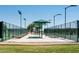 Pickleball courts with covered benches offer a shaded seating area for players and spectators at 15656 W Mercer Ln, Surprise, AZ 85379