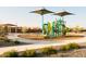 Community playground with slides, climbing structures, and covered seating areas at 15656 W Mercer Ln, Surprise, AZ 85379