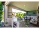 Entertaining patio features an outdoor kitchen, relaxing seating, and easy access to the well-manicured yard at 17168 W Mountainair St, Surprise, AZ 85388