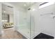 Bright bathroom features a frameless glass shower with a built-in bench and a view to the bedroom at 17168 W Mountainair St, Surprise, AZ 85388
