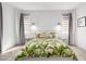 Bright bedroom with neutral tones features a tropical-themed bed set and bedside tables with matching lamps at 17168 W Mountainair St, Surprise, AZ 85388