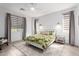Serene bedroom featuring neutral tones, custom window coverings, and ample natural light at 17168 W Mountainair St, Surprise, AZ 85388