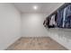 Walk-in closet with custom shelving and rods provides ample storage space for clothing and accessories at 17168 W Mountainair St, Surprise, AZ 85388