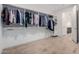 Spacious walk-in closet with custom shelving and rods provides ample storage space for clothing and accessories at 17168 W Mountainair St, Surprise, AZ 85388