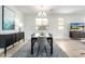Bright dining room boasts modern chandelier, neutral colors, and plenty of natural light at 17168 W Mountainair St, Surprise, AZ 85388