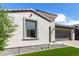 Beautiful home exterior with a decorative stone window frame, low-water landscaping, and a paved driveway at 17168 W Mountainair St, Surprise, AZ 85388