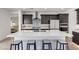 Bright kitchen features a large island with seating, dark wood cabinets, and modern appliances at 17168 W Mountainair St, Surprise, AZ 85388