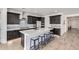 Modern kitchen with large island, stainless appliances, custom tile backsplash, and ample lighting at 17168 W Mountainair St, Surprise, AZ 85388