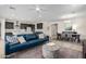 Open-concept living space with a modern kitchen, dining area, and comfortable seating arrangement at 17168 W Mountainair St, Surprise, AZ 85388