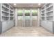 Bright living space features custom shelving, tile floors, and windows offering ample natural light at 17168 W Mountainair St, Surprise, AZ 85388