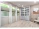 Office boasts natural light from three windows, built-in shelving, and comfortable accent chair at 17168 W Mountainair St, Surprise, AZ 85388