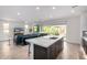 Bright, open-concept space with large island, modern decor, and seamless indoor-outdoor living at 17168 W Mountainair St, Surprise, AZ 85388