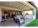 Covered patio features outdoor seating and overlooks the kitchen and living room at 17168 W Mountainair St, Surprise, AZ 85388