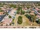 Aerial view of neighborhood showing park with lush green grass and mature trees amongst single Gathering homes at 1754 W San Tan St, Chandler, AZ 85224