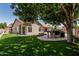 Great backyard with outdoor cooking area, mature landscaping, and artificial turf at 1754 W San Tan St, Chandler, AZ 85224