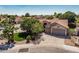 View of home's front exterior with a two car garage, desert landscaping, and mature trees at 1754 W San Tan St, Chandler, AZ 85224