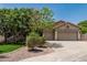 Charming single-story home featuring a well-manicured lawn, mature trees, and a spacious three-car garage at 1754 W San Tan St, Chandler, AZ 85224