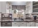 Close-up of kitchen sink with stainless steel appliances and granite backsplash at 1754 W San Tan St, Chandler, AZ 85224