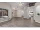 Open living space with arched doorways, wood-look floors, and access to other rooms in the home at 1754 W San Tan St, Chandler, AZ 85224
