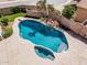 A kidney shaped private pool features a spa and stone facade bar under shade of mature tree at 1754 W San Tan St, Chandler, AZ 85224