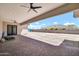 Cozy covered back patio with ceiling fans, perfect for outdoor dining and relaxation at 18225 W San Juan Ct, Litchfield Park, AZ 85340