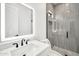 Modern bathroom with sleek vanity, lighted mirror, and glass-enclosed shower at 18225 W San Juan Ct, Litchfield Park, AZ 85340