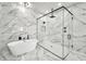 Bright bathroom featuring a soaking tub and separate glass-enclosed shower with marble surround at 18225 W San Juan Ct, Litchfield Park, AZ 85340