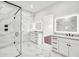 Luxurious bathroom featuring dual vanities, large mirrors, glass shower, and marble tile flooring at 18225 W San Juan Ct, Litchfield Park, AZ 85340