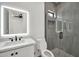 Modern bathroom with sleek vanity, lighted mirror, and glass-enclosed shower at 18225 W San Juan Ct, Litchfield Park, AZ 85340