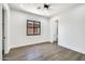 Bright bedroom with wood-look tile flooring, a ceiling fan, and natural light at 18225 W San Juan Ct, Litchfield Park, AZ 85340