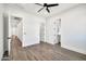 Bright bedroom with wood-look tile flooring, ceiling fan, and ensuite bathroom at 18225 W San Juan Ct, Litchfield Park, AZ 85340