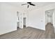 Bright bedroom with wood-look flooring and access to the bathroom and closet at 18225 W San Juan Ct, Litchfield Park, AZ 85340