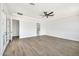 Spacious bedroom with wood-look tile flooring, ceiling fan, and ensuite bathroom at 18225 W San Juan Ct, Litchfield Park, AZ 85340