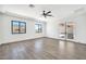 Airy bedroom offers dual windows, french doors, wood flooring, and neutral walls at 18225 W San Juan Ct, Litchfield Park, AZ 85340
