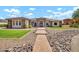 Attractive house featuring stonework accents and a well-maintained lawn at 18225 W San Juan Ct, Litchfield Park, AZ 85340