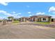 Beautiful home exterior with landscaped rock features and lush green synthetic grass at 18225 W San Juan Ct, Litchfield Park, AZ 85340