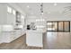 Spacious kitchen boasts a center island, stainless steel appliances, and white cabinetry at 18225 W San Juan Ct, Litchfield Park, AZ 85340