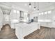 Bright kitchen featuring a center island, quartz countertops, custom cabinetry, and stainless appliances at 18225 W San Juan Ct, Litchfield Park, AZ 85340