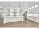 Large kitchen with white cabinetry, center island, pendant lights, and stainless steel appliances at 18225 W San Juan Ct, Litchfield Park, AZ 85340
